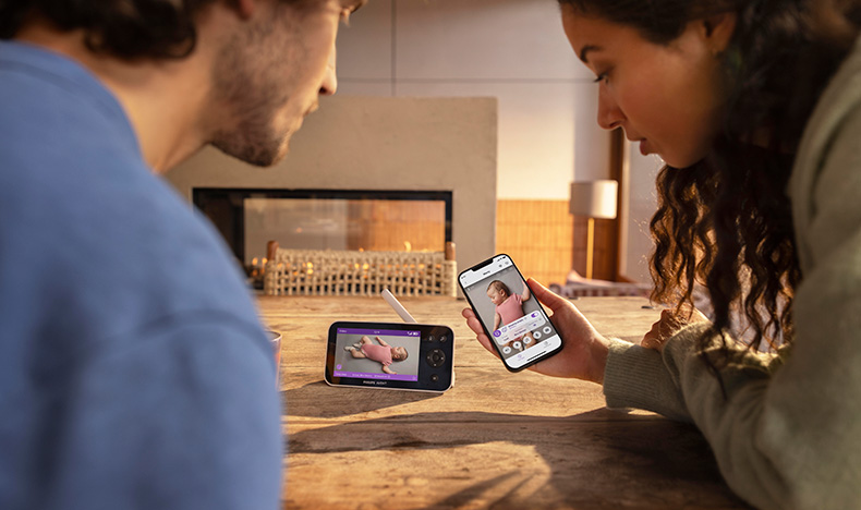 Parents monitoring their baby on their smartphone